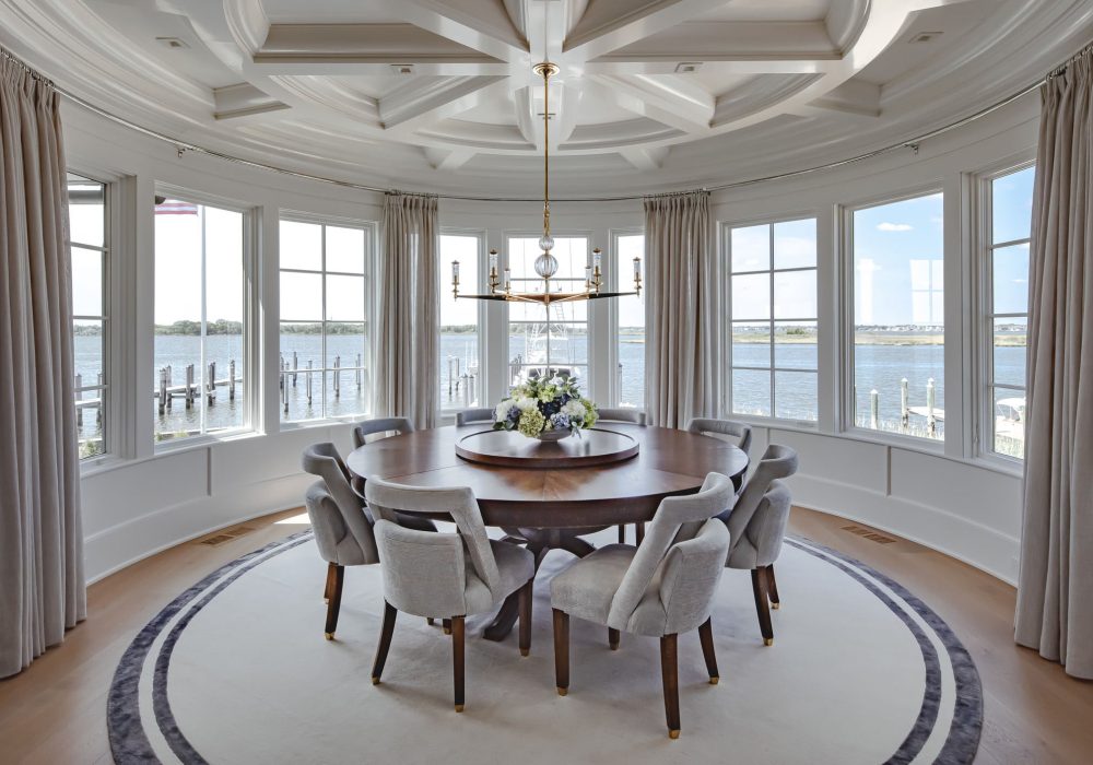 Solid plain rug design with a border in a spectacular coastal home. White rug with black silk border.